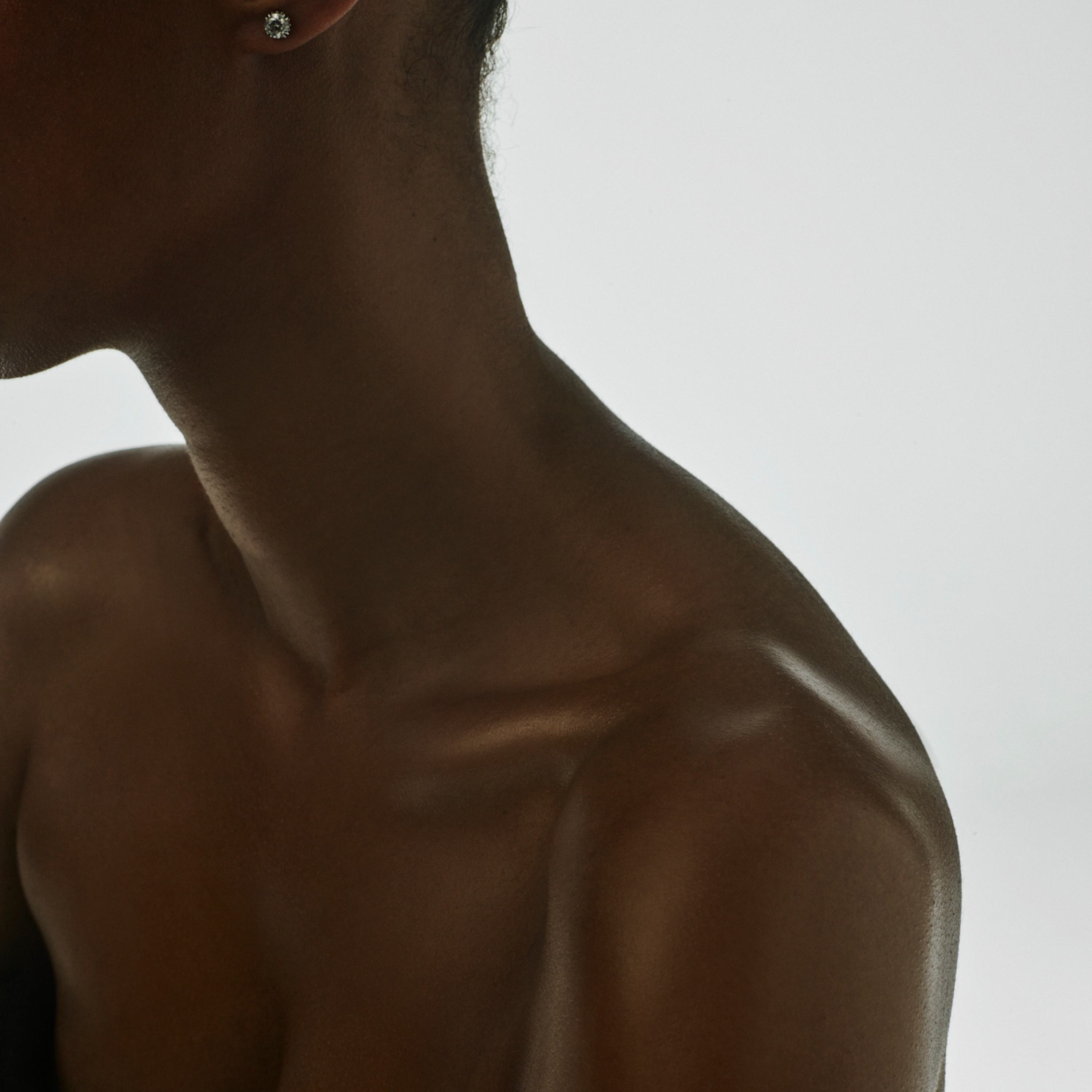 Close-up of radiant, hydrated skin along a neck and shoulder line.