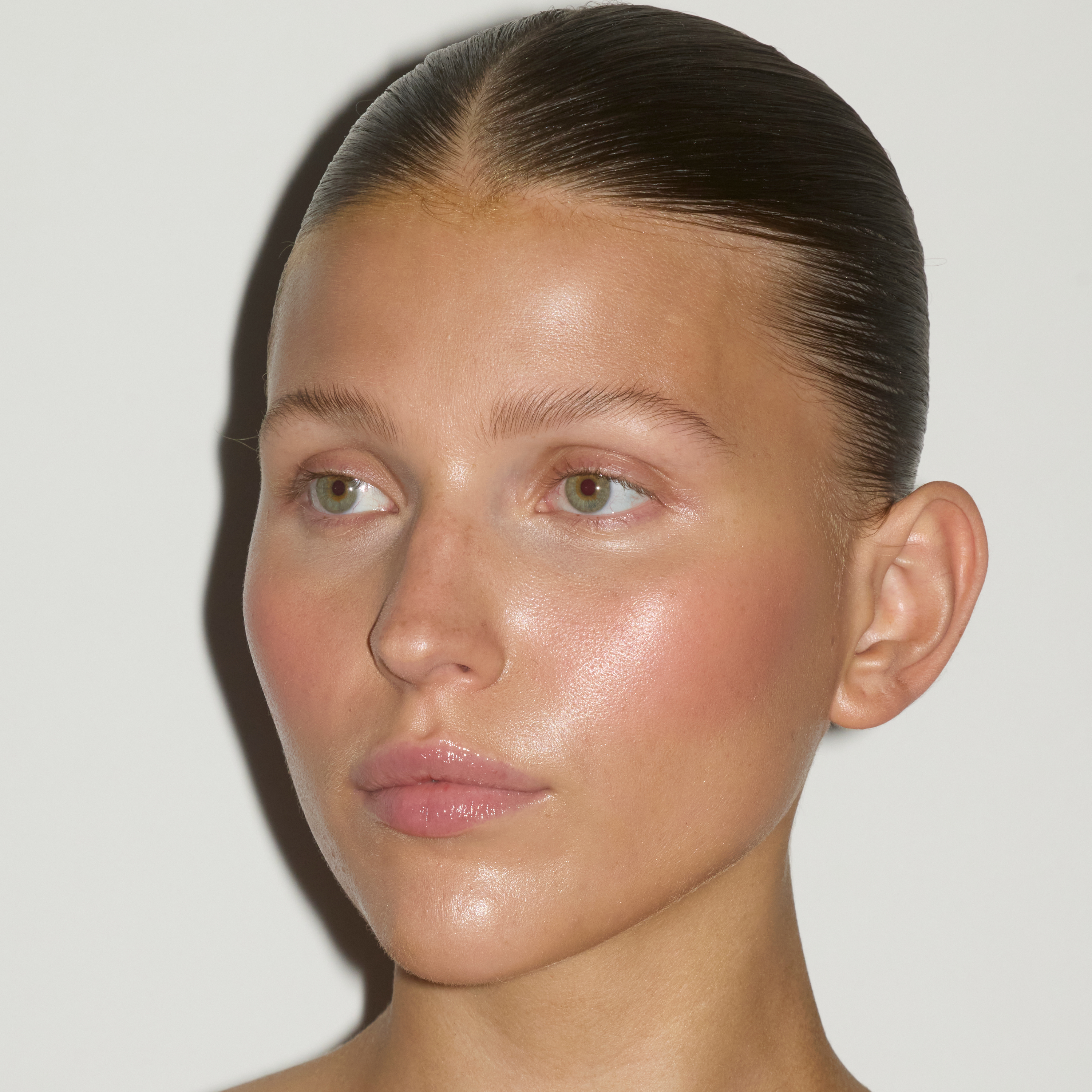 Model wearing a fresh, dewy base applied with the SOPHIA MAE Liquid Blending Brush.