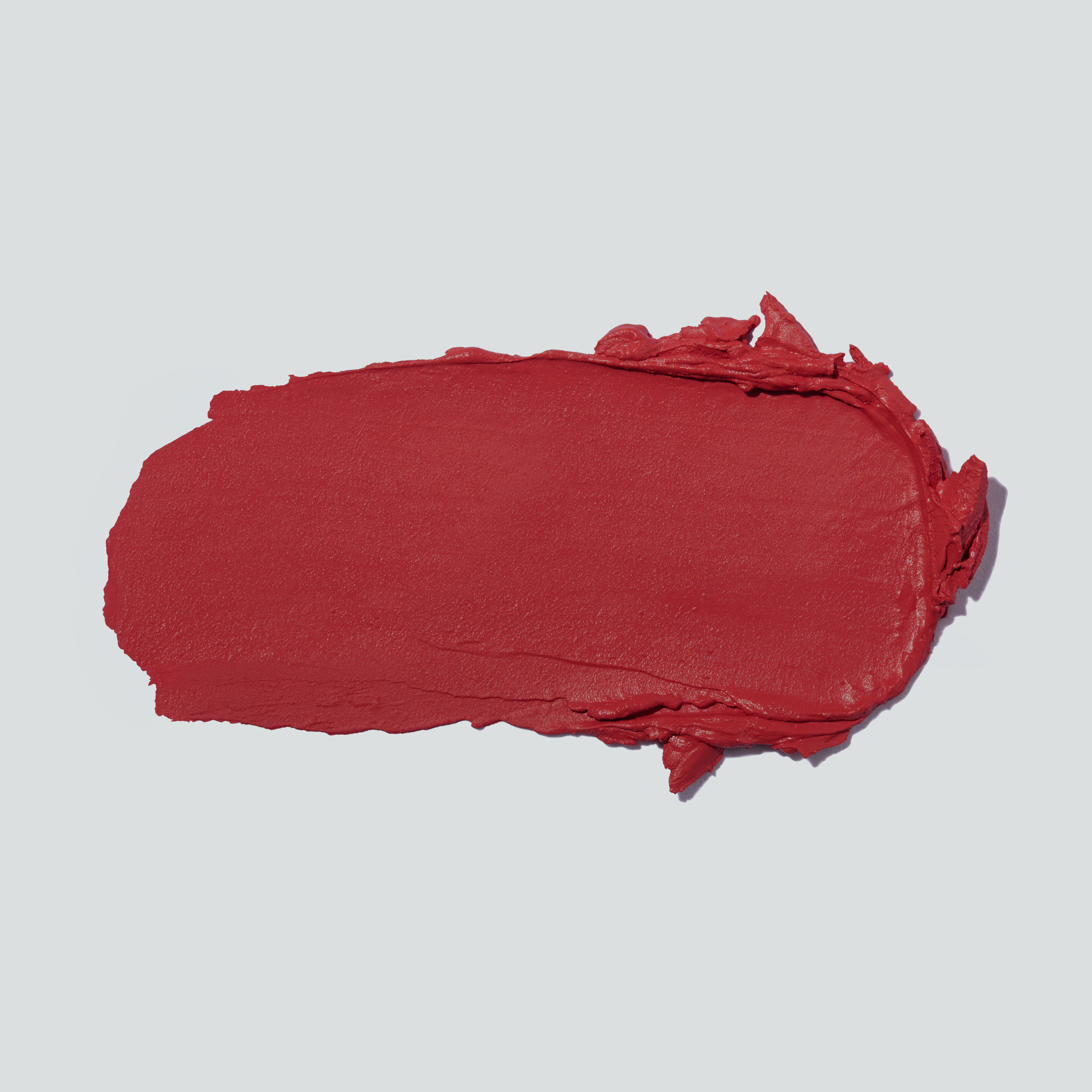 Close-up swatch of the rosy red cream texture of SOPHIA MAE Tan Blusher.