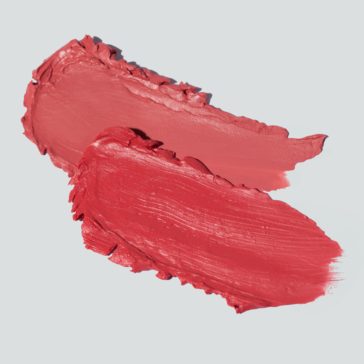 Close-up of SOPHIA MAE Cream Blush swatches in two pink and coral shades.