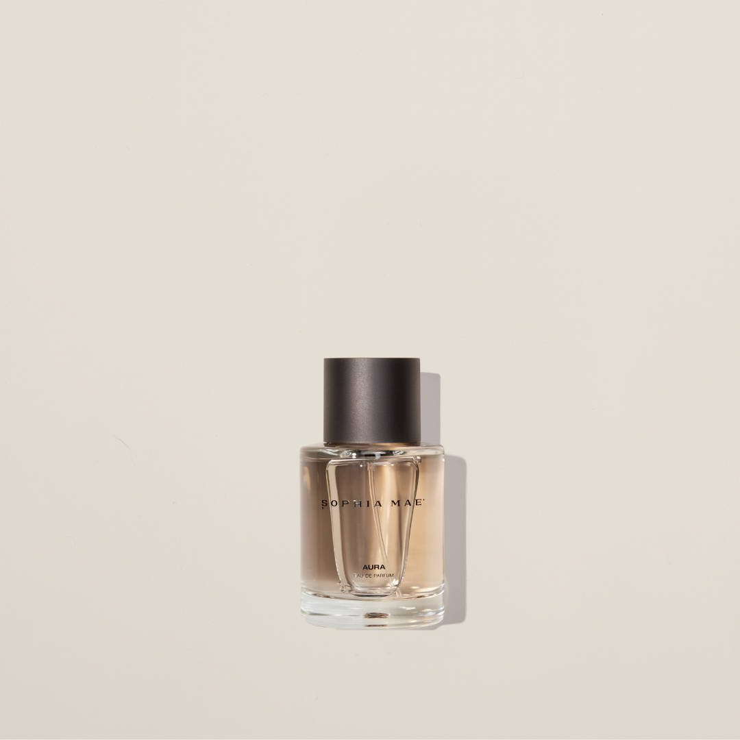 Aura eau de parfum with cotton, jasmine, amber, and musk – a warm, layered fragrance with soft sweetness and sensual depth.