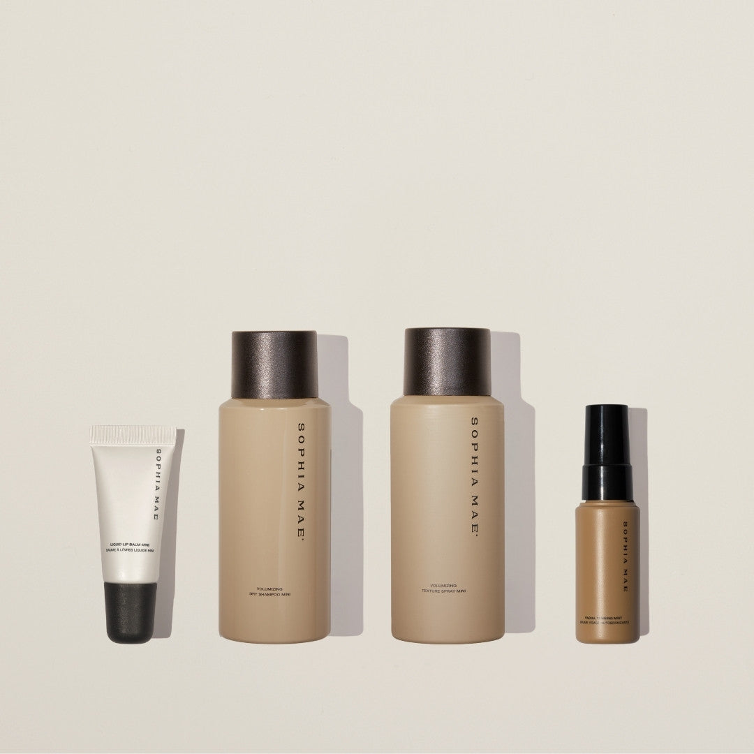 Travel beauty set with mini lip balm, mini dry shampoo, mini texture spray, and mini self tanner.