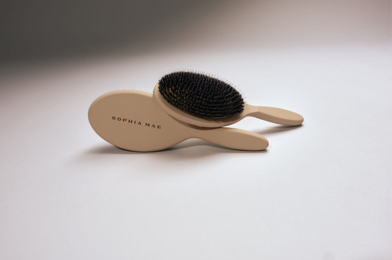 SOPHIA MAE hairbrushes in a soft beige colour with elegant curved handles.