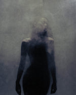 Atmospheric portrait for SOPHIA MAE For A Reason Eau de Parfum, featuring a softly blurred silhouette in a dark, smoky setting that reflects the fragrance’s warm, mysterious mood.