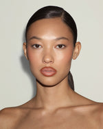 Model wearing SOPHIA MAE Lip Liner in Warm Spice, creating a softly defined warm nude lip look.