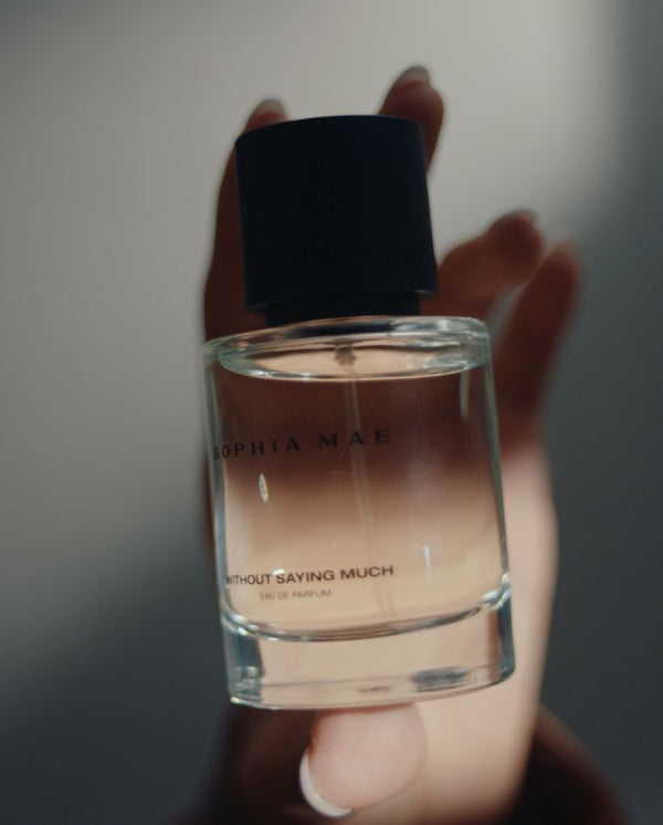 Model holds Without Saying Much eau de parfum SOPHIA MAE. 