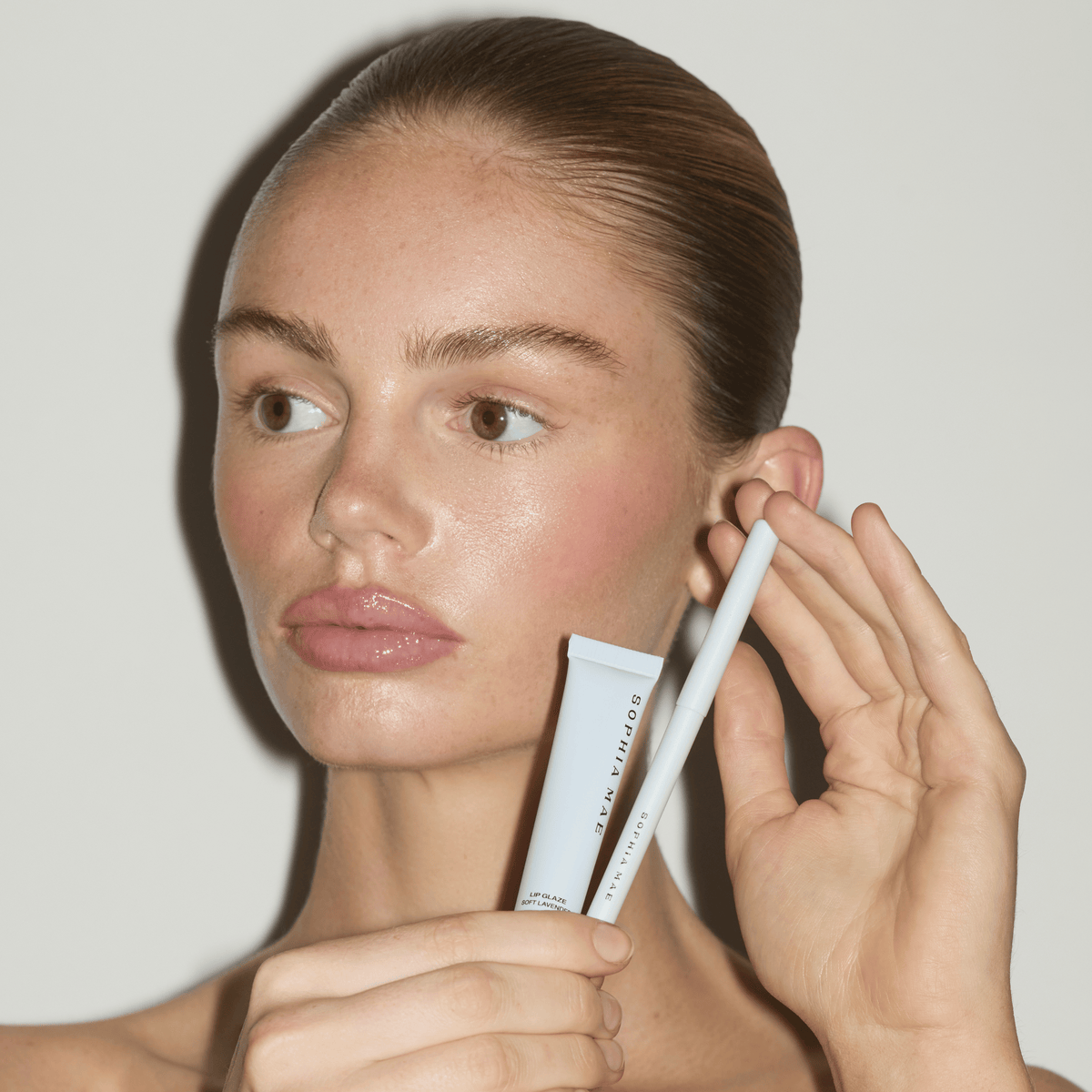 Model wearing Lip Glaze Soft Lavender combined with a Lip Liner.