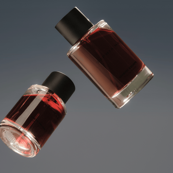 Two SOPHIA MAE Mystic Escape eau de parfum bottles floating against a dark grey background.