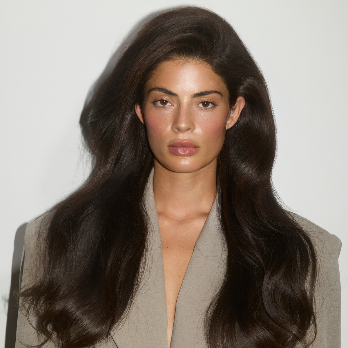 Woman with long, voluminous hair styled using SOPHIA MAE Volumizing Dry Shampoo.