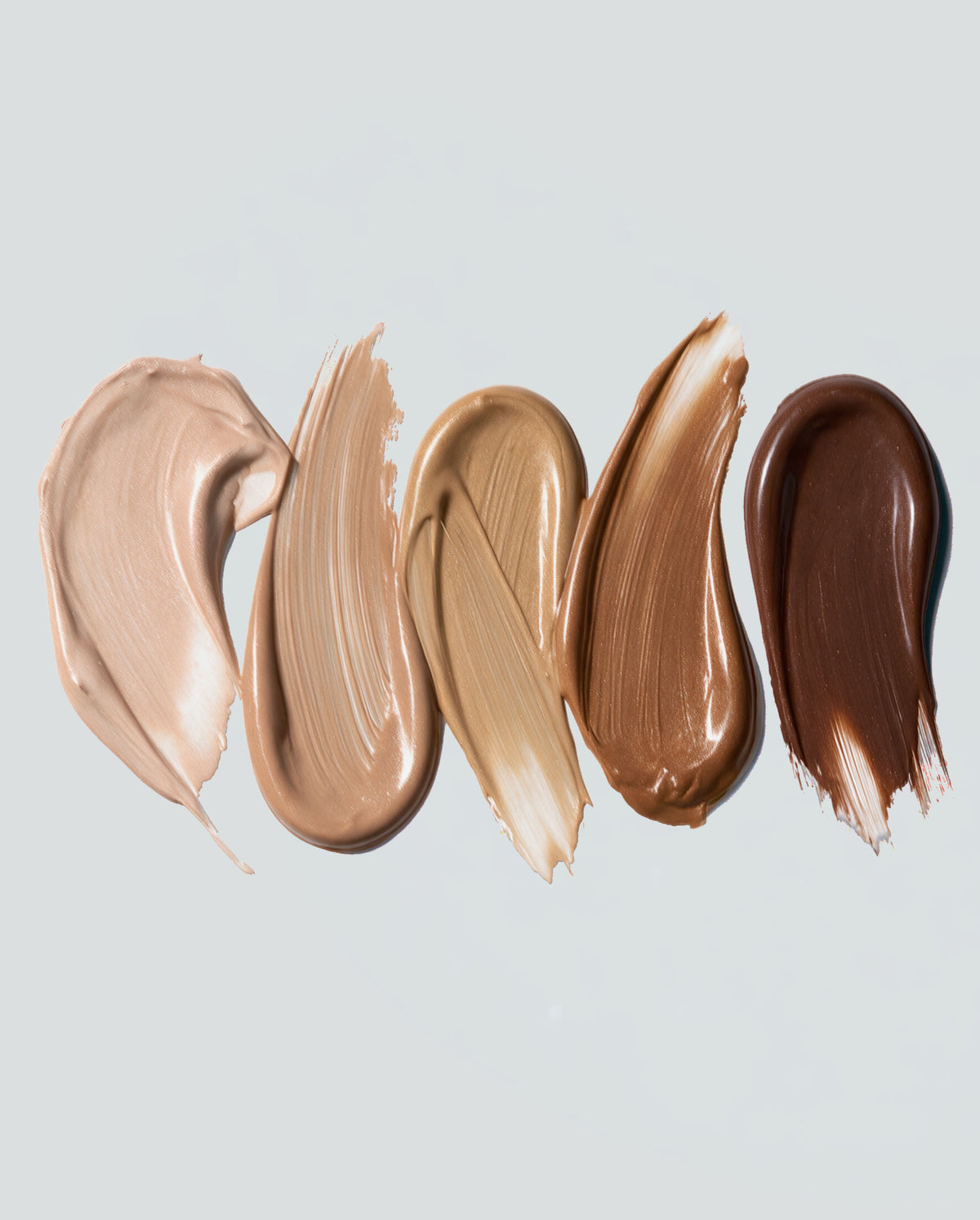 Five SOPHIA MAE Skin Tint swatches ranging from light to deep shades, showing the smooth, creamy texture and natural skin-like finish.