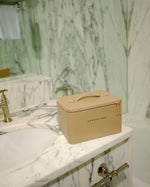 Closed SOPHIA MAE Beauty Case on a marble bathroom counter.