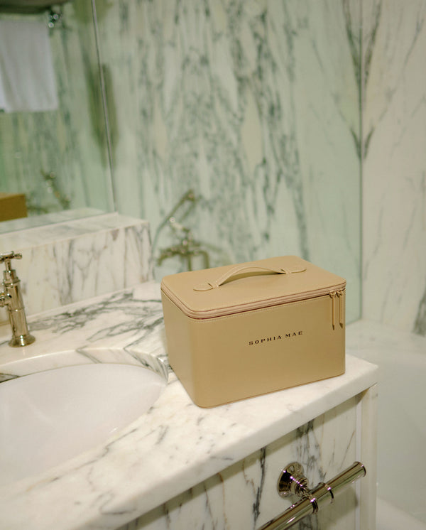 Closed SOPHIA MAE Beauty Case on a marble bathroom counter.