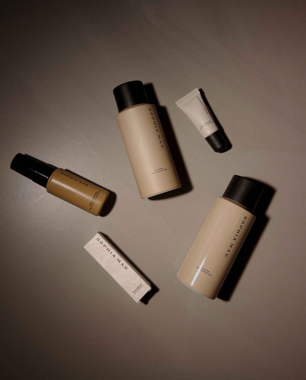 Top view of the SOPHIA MAE Bestseller selection with For a Reason eau de parfum, Volumizing Dry Shampoo, Texture Spray, Facial Tanning Mist and Liquid lip balm.