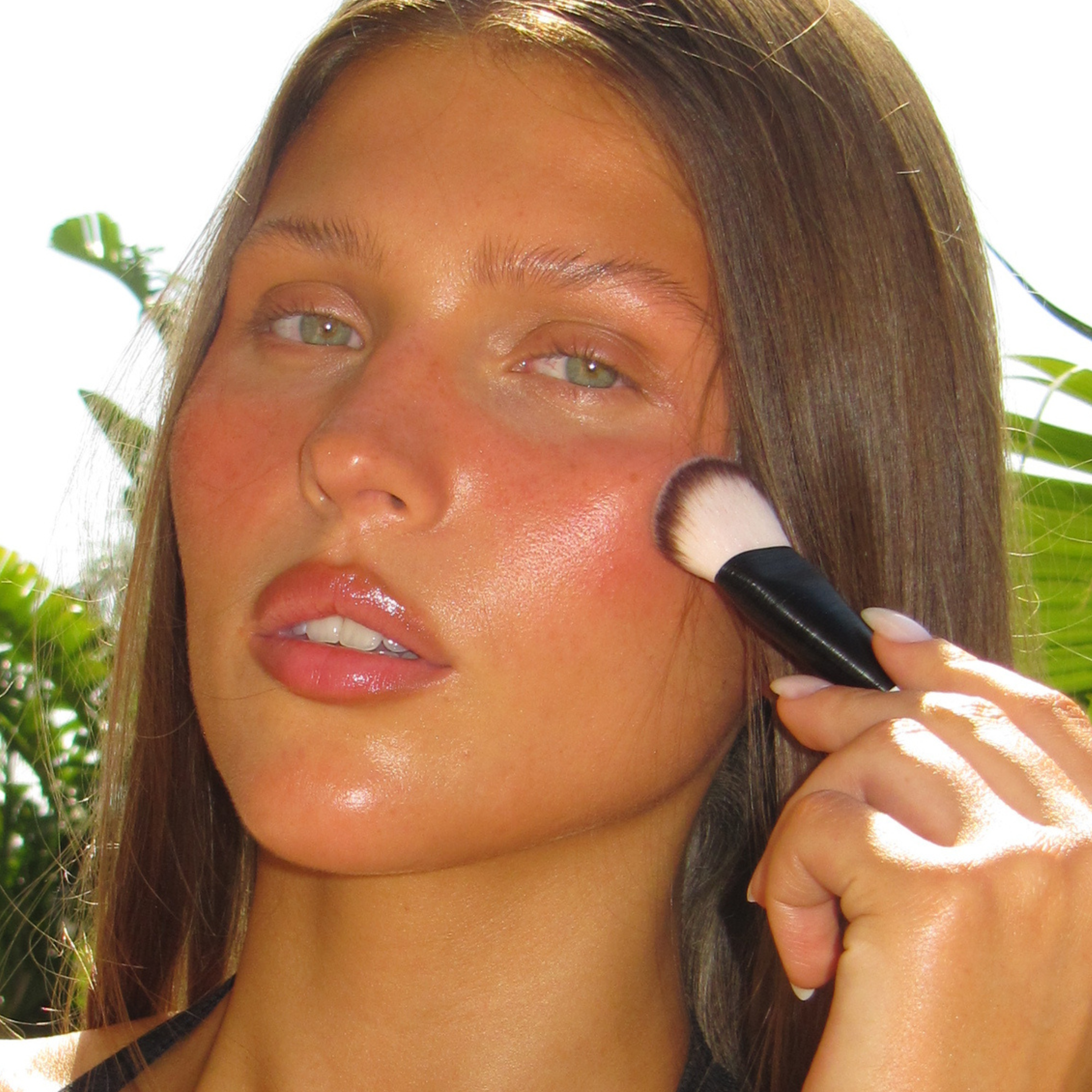 Model using the SOPHIA MAE Liquid Blending Brush to apply Cream Blush for a luminous, skin-like finish.