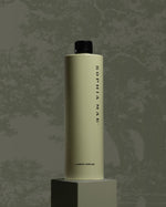 SOPHIA MAE fragrance bottle displayed on a pedestal against a textured grey background.