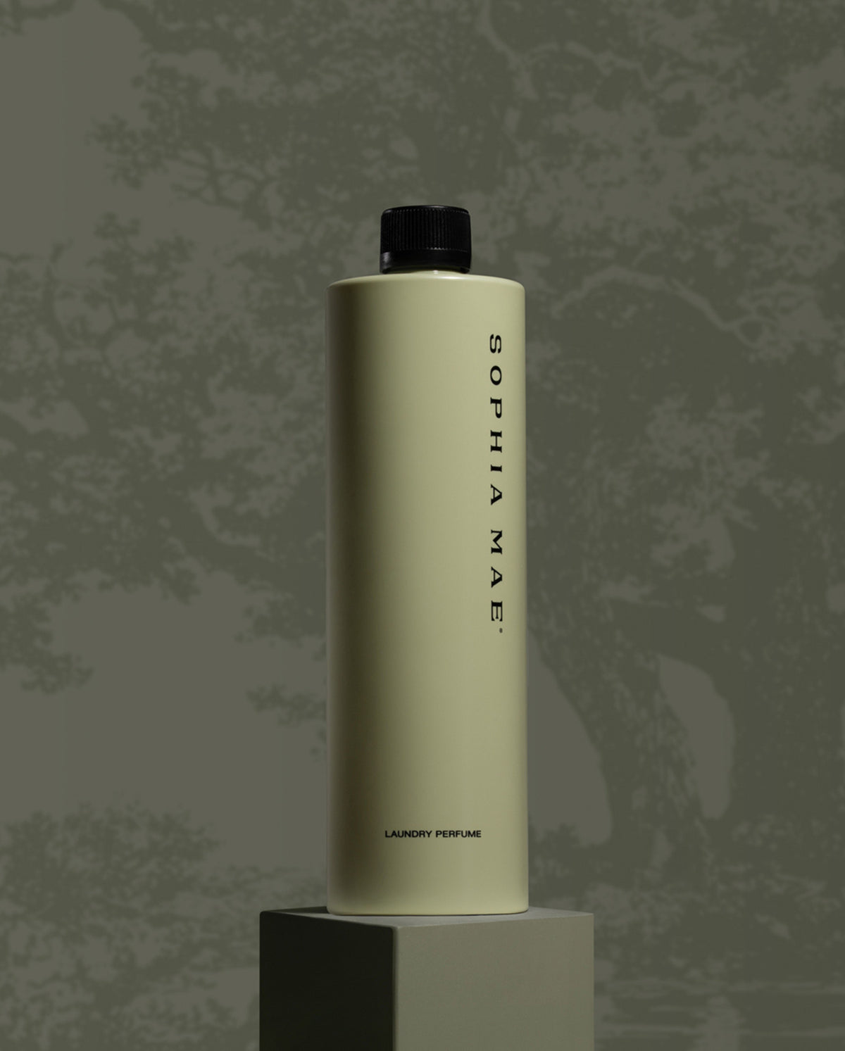 SOPHIA MAE fragrance bottle displayed on a pedestal against a textured grey background.