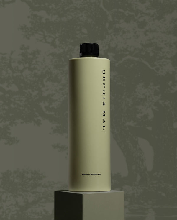 SOPHIA MAE fragrance bottle displayed on a pedestal against a textured grey background.