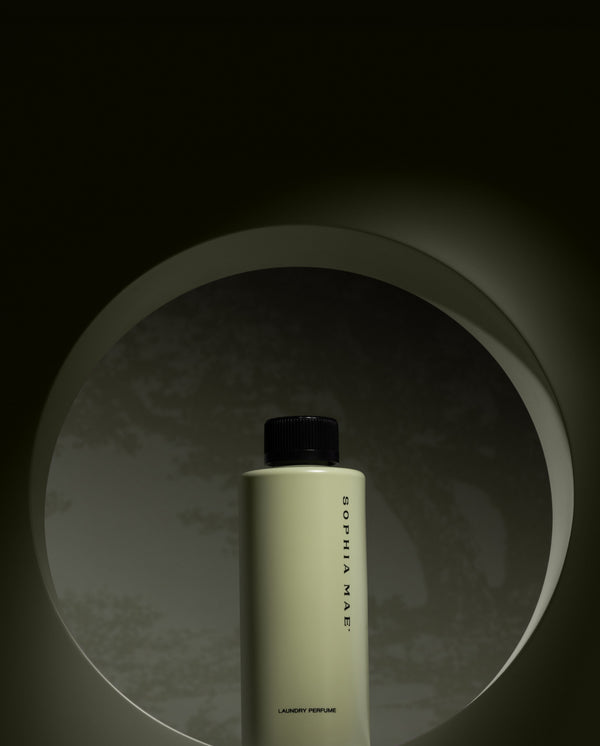 SOPHIA MAE fragrance bottle in a minimalist circular alcove with soft lighting.