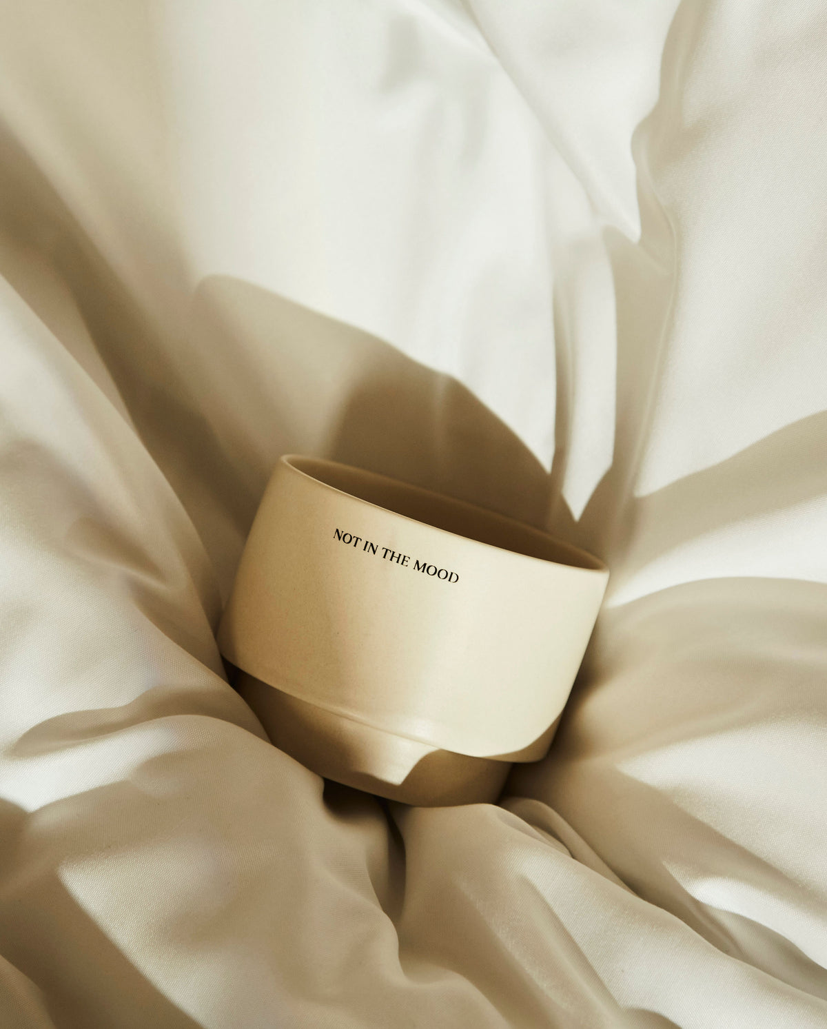 SOPHIA MAE mug nestled in soft white bedding with the text not in the mood. 