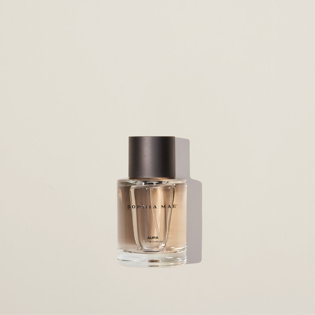 Aura eau de parfum with cotton, jasmine, amber, and musk – a warm, layered fragrance with soft sweetness and sensual depth.