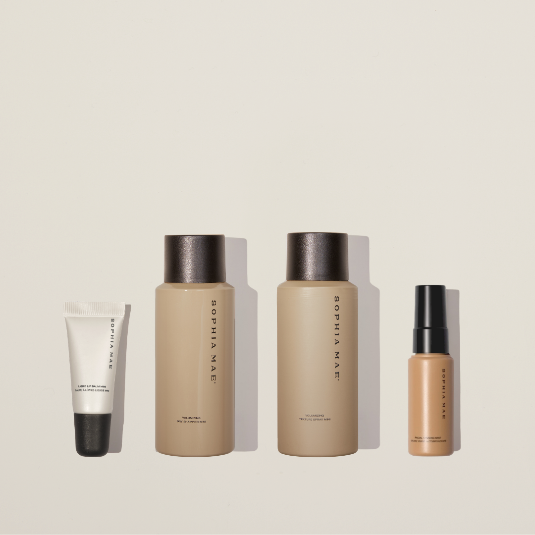 Travel beauty set with mini lip balm, mini dry shampoo, mini texture spray, and mini self tanner.