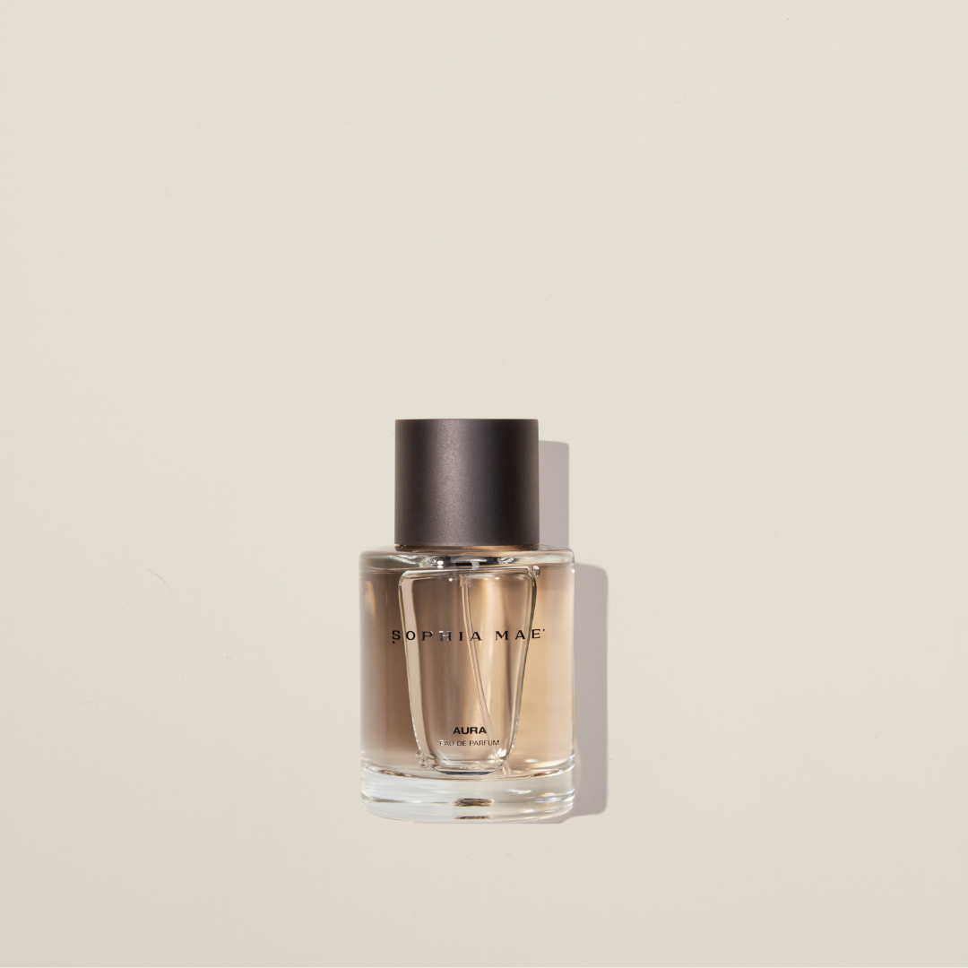 Aura eau de parfum with cotton, jasmine, amber, and musk – a warm, layered fragrance with soft sweetness and sensual depth.