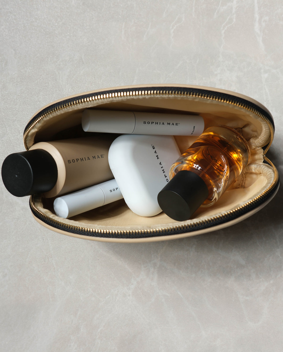 Open SOPHIA MAE Beauty Bag filled with beauty essentials, perfume and makeup products.