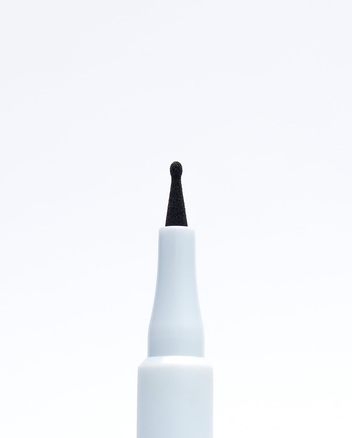 Macro view of the fine, flexible applicator tip of the SOPHIA MAE Freckle Pen for precise dotting.