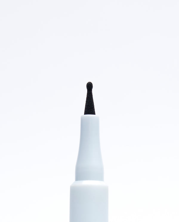 Macro view of the fine, flexible applicator tip of the SOPHIA MAE Freckle Pen for precise dotting.
