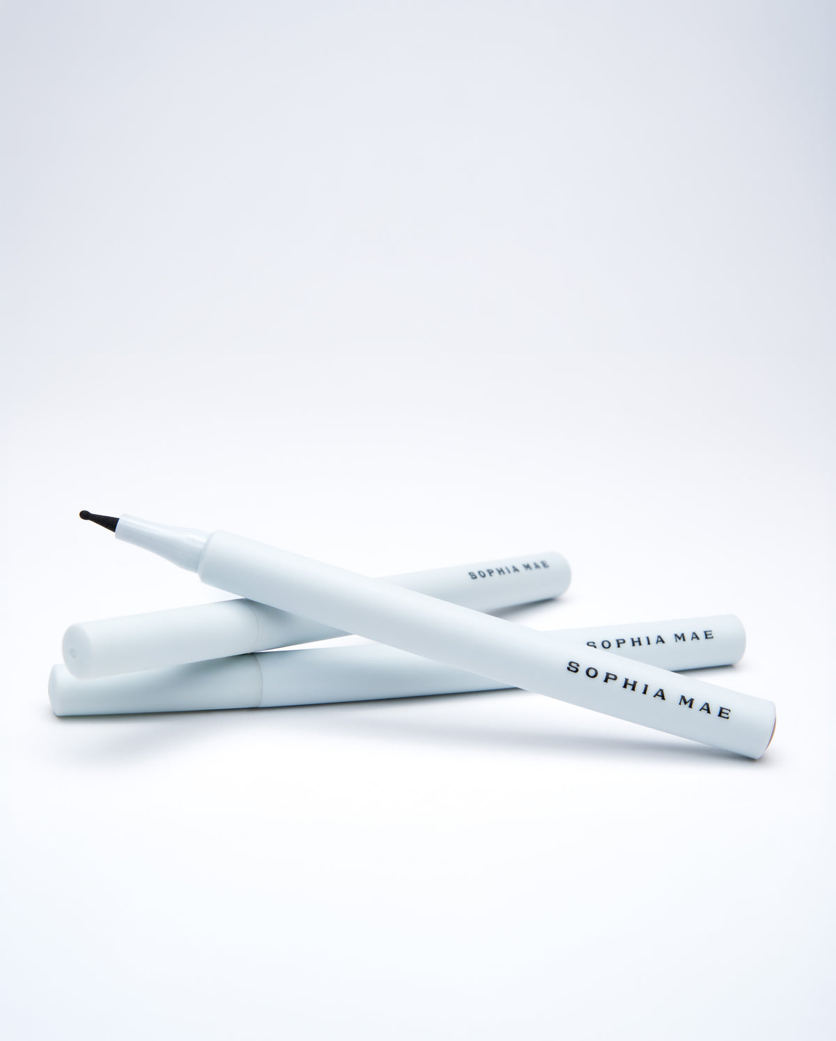 Three SOPHIA MAE Freckle Pens with white casing and black branding stacked on a clean white background.