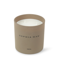 SOPHIA MAE Hestia two-wick candle in a soft beige glass vessel.