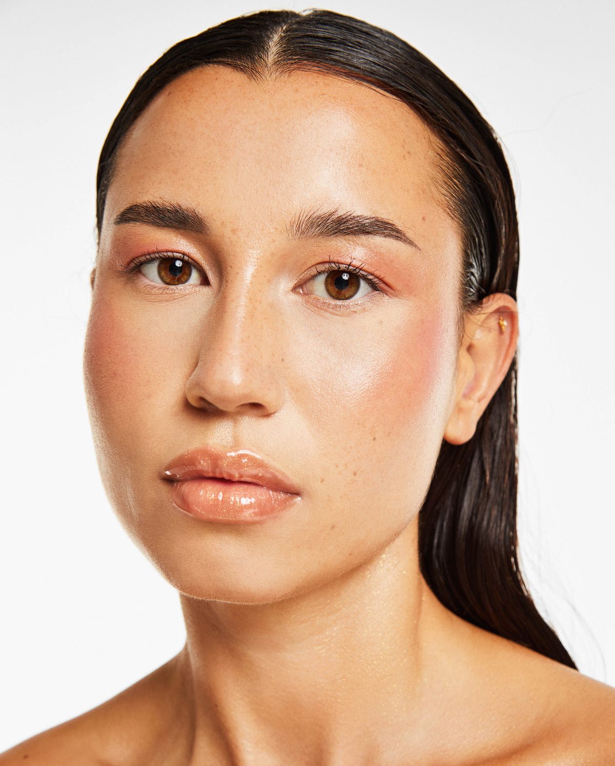 Front-facing portrait of a model wearing SOPHIA MAE Plumping Lip Allure with a glossy finish.