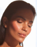 Close-up portrait of Monica Geuze with glowing skin and glossy lips wearing SOPHIA MAE Plumping Lip Allure.