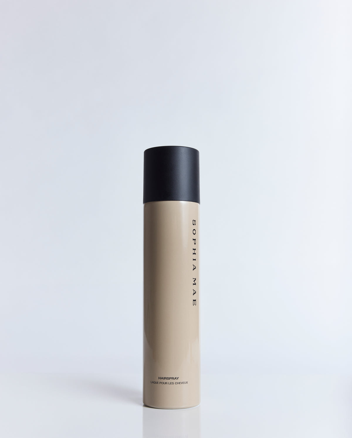 SOPHIA MAE Hairspray in its signature beige bottle with a matte black cap, photographed against a clean studio background.