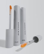 Product shot of SOPHIA MAE Plumping Lip Allure with tubes and applicators displayed on a light background.