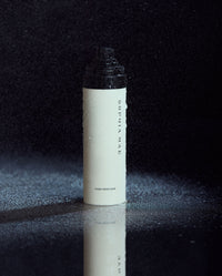 SOPHIA MAE Hair Perfume bottle with fine mist on a dark background.