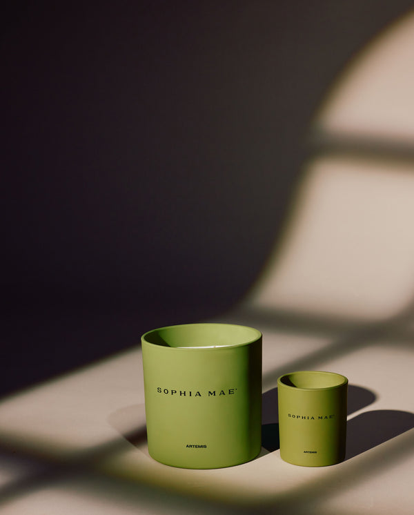 SOPHIA MAE Artemis scented candle in a green jar next to a smaller one. 