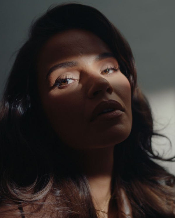 Monica Geuze in light and shadow, capturing the intimate mood of SOPHIA MAE Without Saying Much Eau de Parfum.
