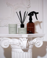 SOPHIA MAE Aphrodite Midi Scented Candle in a soft sage green jar, styled alongside the matching reed diffuser on an ornate white mantel.