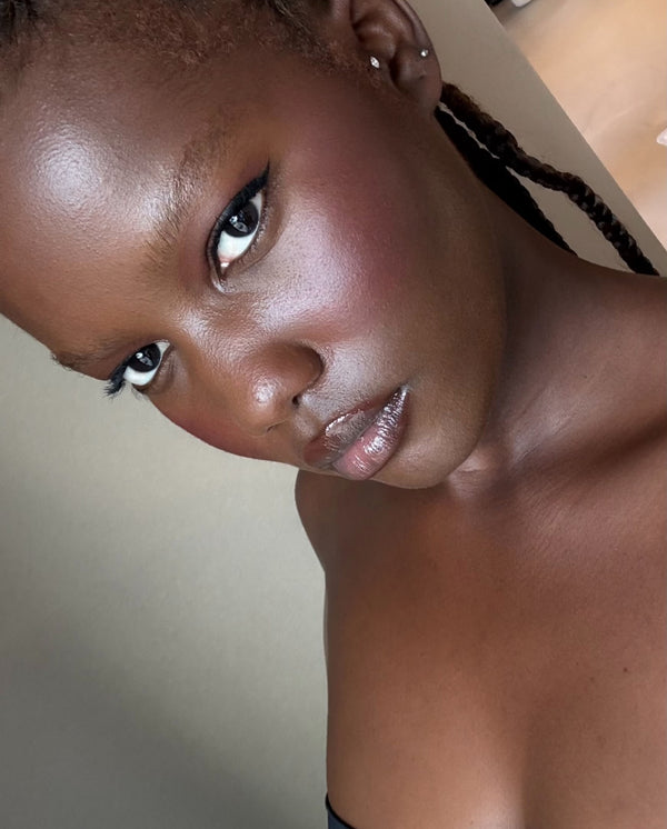 Close-up portrait of a model wearing SOPHIA MAE Skin Tint, showing an even complexion with a natural, dewy glow and skin-like finish.