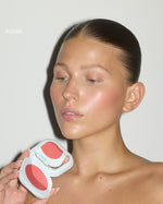 Model holding open SOPHIA MAE Cream Blush in the shade Rose.