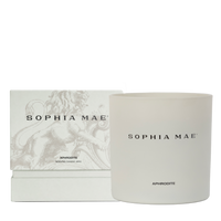 Packaging of and the Aphrodite scented candle with notes of vanilla, amber, and musk.