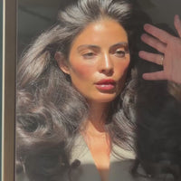 Woman showing voluminous, textured hair styled with SOPHIA MAE Volumizing Texture Spray.