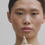 Close-up of Liquid Lip Balm being applied to the upper and lower lips for an even, glossy finish.