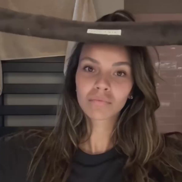 Woman wearing the brown SOPHIA MAE Headband while applying skincare to her face.