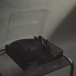 Black-and-white campaign film featuring a record player, shadowed portraits, drifting fragrance mist and Without Saying Much eau de parfum.